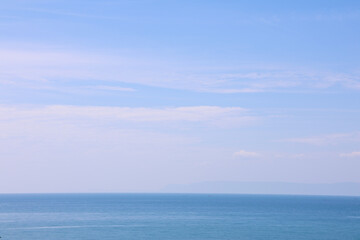 Vast Tranquil Ocean and Clear Blue Sky Background with Distant Horizon