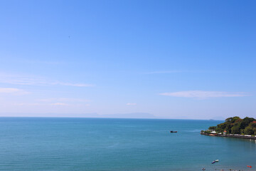 Tropical Blue Seascape with Clear Sky and Distant Resort Coastline