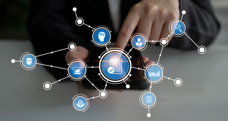 This image features a hand using a smartphone to interact with digital icons, illustrating modern communication and data integration in a professional setting. Crux