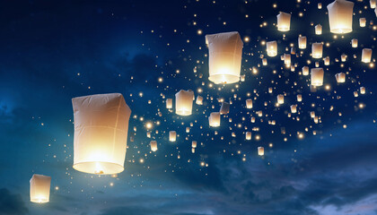 Sky lanterns floating in the night sky, creating a magical and festive atmosphere.