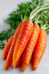 Close-up of a bunch of ripe carrots with tops isolated on a white background