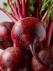 Close-up of a bunch of ripe beets with leaves isolated on a white background