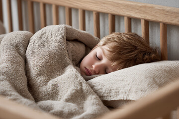 Baby sleeping in a wooden crib, covered with a natural fabric blanket, rustic style, simplicity and comfort