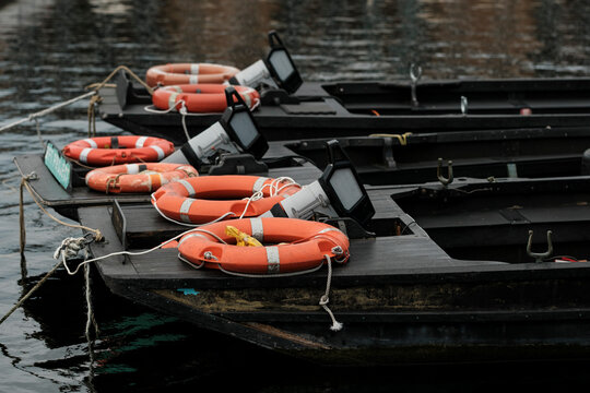 Row of fishing boats moored in a dark harbor