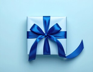 Wrapped present with blue ribbon & bow on light blue