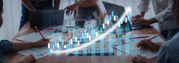 A collaborative business meeting scene with professionals analyzing charts and graphs, showcasing teamwork and modern office dynamics, focusing on data-driven decisions. Axiom