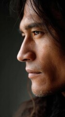 Fototapeta premium A close-up side view of a Native American man with tan natural skin and straight black hair