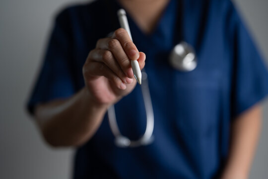 Doctor using digital pen in hospital setting, showing healthcare technology, e-prescription, mobile devices, digital charting, and the evolution of smart medical tools in patient care systems.