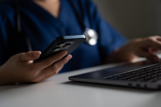 Nurse or doctor using phone and laptop in clinical setting, highlighting telehealth innovations, connected healthcare systems, and digital tools for efficient patient care and online treatment access.