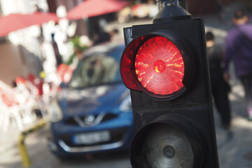 Traffic light displaying red signal in busy urban area