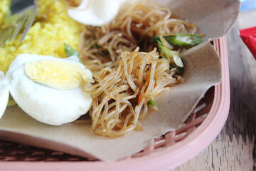 Local Indonesian dish with turmeric rice and crispy crackers.