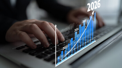 A close-up view of hands typing on a laptop keyboard, overlaid with a digital graph illustrating financial growth projections from 2023 to 2026, symbolizing business success. Tessel