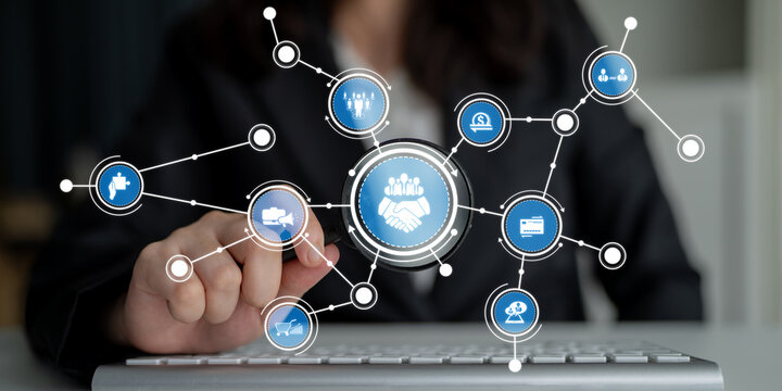 A modern business networking concept featuring a digital handshake icon surrounded by various business-related icons, representing collaboration and connection in the workplace. Crux - Powered by Adobe