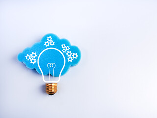 Creative cloud and lightbulb concept with gear icons on white with space, symbolizing smart cloud computing, data management, innovation, intelligent system technology in digital transformation era.