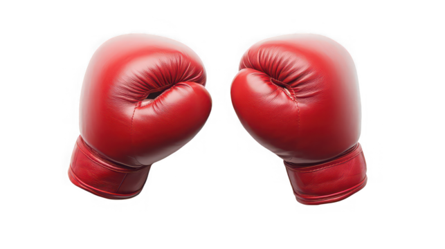 A pair of red boxing gloves facing each other isolated against a plain black studio background