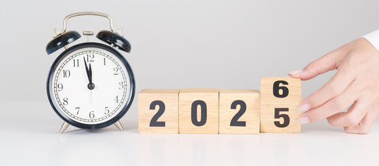 2025 end year to Happy New Year 2026 with vintage alarm clock. Christmas, New Start, Resolution,...