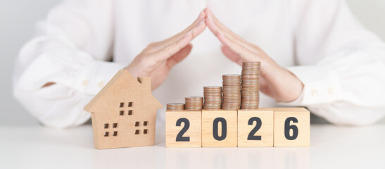 Happy New Year 2026 with hand cover money stack. Insurance, real estate, Home loan, tax,...