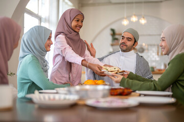 Muslim big family sharing traditional meal together around dining table wearing hijabs and kufi in cultural love, ramadan iftar celebration, eid al-fitr festive, halal meal gathering food culture
