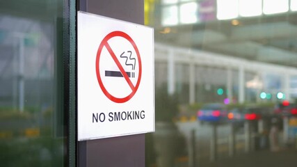No smoking sign displayed at busy airport entrance