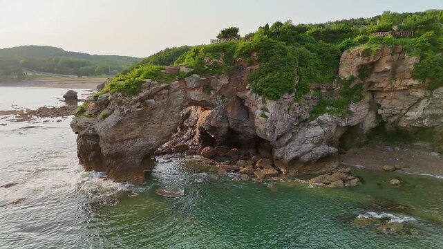 Orbit Drone View of Natural Rock Arch, Dalian Jinshitan National Geopark, Coastal Erosion Landscape, China