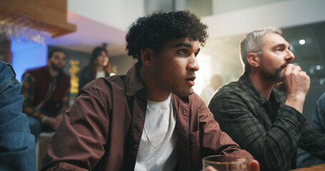 Sport, watching and people in home with wait, anticipation or worry in soccer tournament. Nervous, match and football fans in house with drink, score announcement and joint anxiety in viewing party.