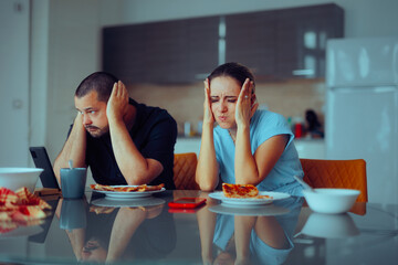 Angry Couple Stop Talking to Each Other at Lunch. Husband and wife avoiding talking to each other at the table being awkward