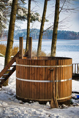 Wooden Outdoor Hot Tub By Snowy Lake With Trees, Stairs, And Winter Calm