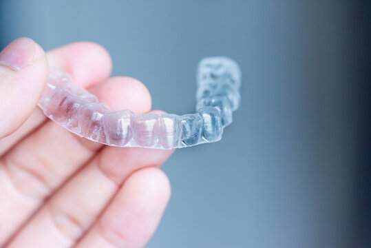  clear aligners device in the mouth on a white background. (invisalign)