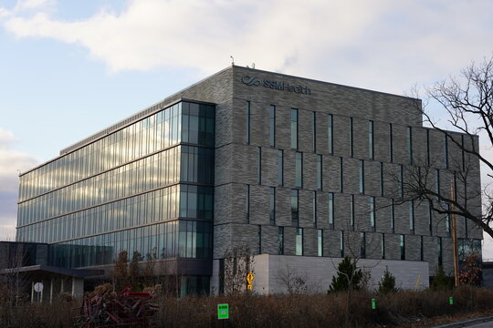 Modern SSM Health building exterior with logo signage on a textured gray facade under a bright sky, suitable for healthcare, corporate, or financial.