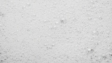 Close-up view of white foam with bubbles, creating a textured and bubbly surface.