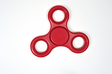 Red Fidget Spinner Toy on White Background | Stress Relief Gadget | Popular Hand Spinner for Focus and Anxiety Relief | Modern Toy Trend
