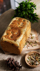 A whole loaf of fresh peanut flavored bread is arranged on the table, ready for breakfast.