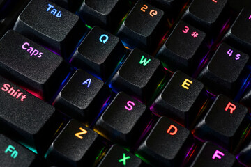RGB-lit gaming keyboard, focus on Tab, Caps, Shift.