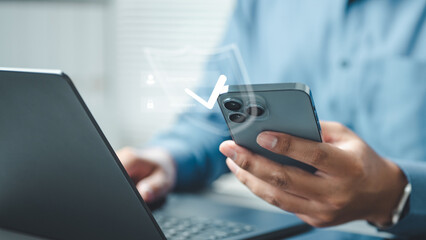 cybersecurity, security, privacy, encryption, firewall, network, A person using a smartphone and laptop with a security check icon, representing cybersecurity, authentication, and data protection.