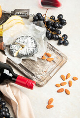 Bottle and glasses of red wine with snacks. Party concept.