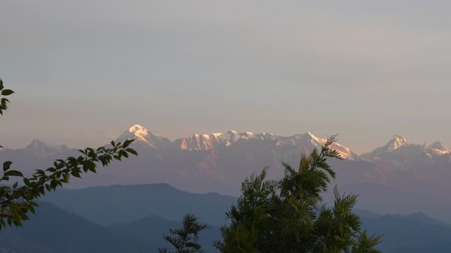 Stunning Alpenglow on Himalayan snow peaks during sunrise, golden pink light on mountains, scenic view from Almora Uttarakhand 4K