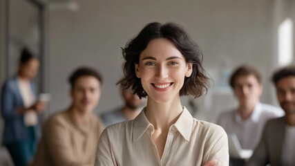 Confident young woman with team in background during business meeting, professional office setting