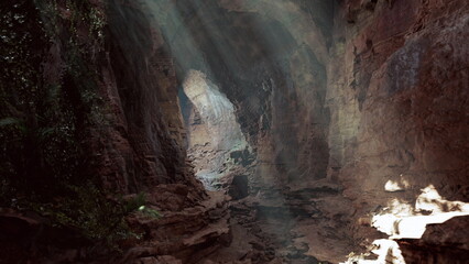 In a serene cave, beams of sunlight pierce through natural openings, illuminating rocky surfaces and vibrant green plants. The atmosphere is tranquil and enchanting, inviting exploration.