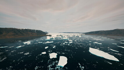 Breathtaking icebergs drift peacefully on dark blue water, surrounded by misty mountains under a soft twilight sky. The serene beauty captures the essence of remote Arctic landscapes. © icetray