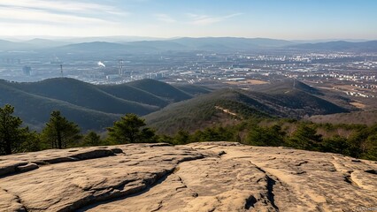 Panoramic View of a Valley and City from a Mountain Peak.