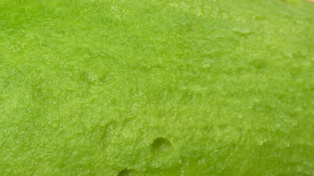 Static extreme macro of avocado green flesh texture. Detailed rough pulp background. Abstract healthy organic food concept.