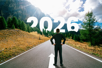 2026 New Year journey and future vision concept . Businessman traveling on highway road leading...
