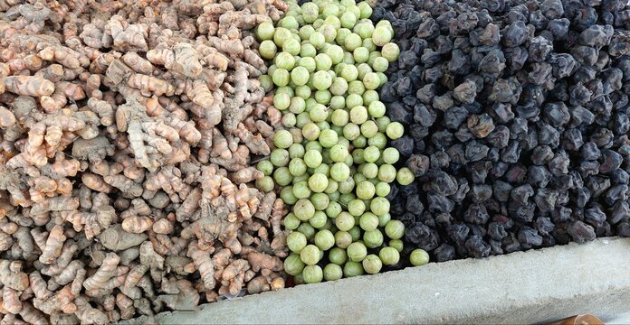 Colorful turmeric Amla and Singhara produce arranged in market
