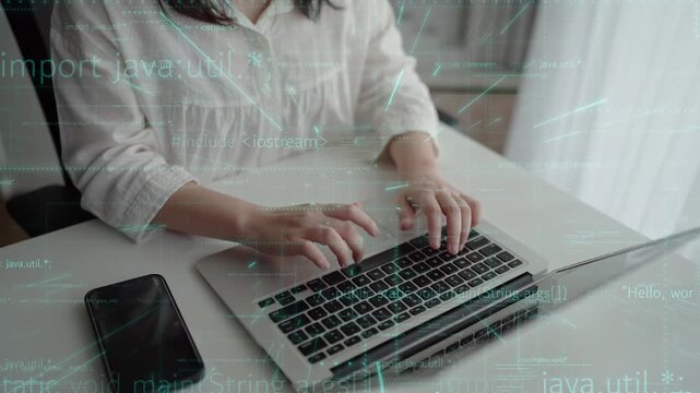 A young person works intently on a laptop, featuring programming code on the screen, representing innovation and technology in a modern workspace setting. Xenic