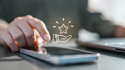 Naklejka premium Close-up of a hand using a smartphone with a reward and loyalty icon, symbolizing point redemption, cashback offers, promo benefits, and digital membership programs.