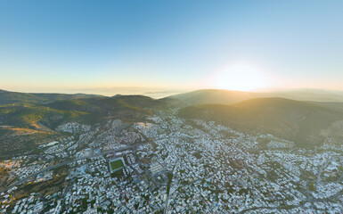 Bodrum, Turkey. Geographic morning overview displaying city settlement patterns, mountain terrain formation, and coastal development in clear morning light. Aerial view