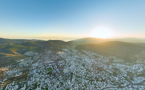 Bodrum, Turkey. Geographic morning overview displaying city settlement patterns, mountain terrain formation, and coastal development in clear morning light. Aerial view