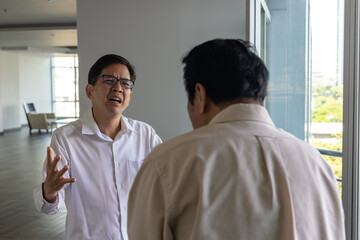 A businessman waiting for his colleague who is coming late. The man gets angry, shouting at his colleague