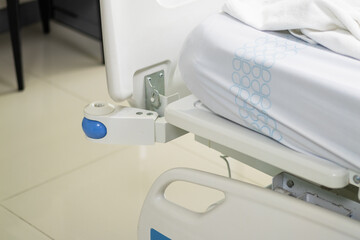 Close-up view of patient bed adjustment in a clean hospital room healthcare equipment focus