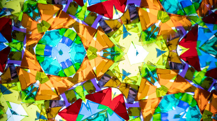 Vibrant macro photography of a natural kaleidoscope pattern, captured on camera. Bright, geometric abstract design with intense colors and light.